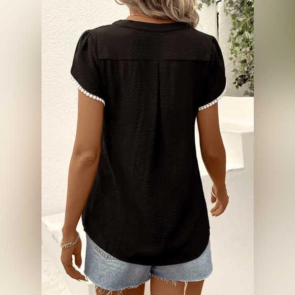 This blouse is a black patchwork short sleeve V neck blouse. - Picture 2 of 5